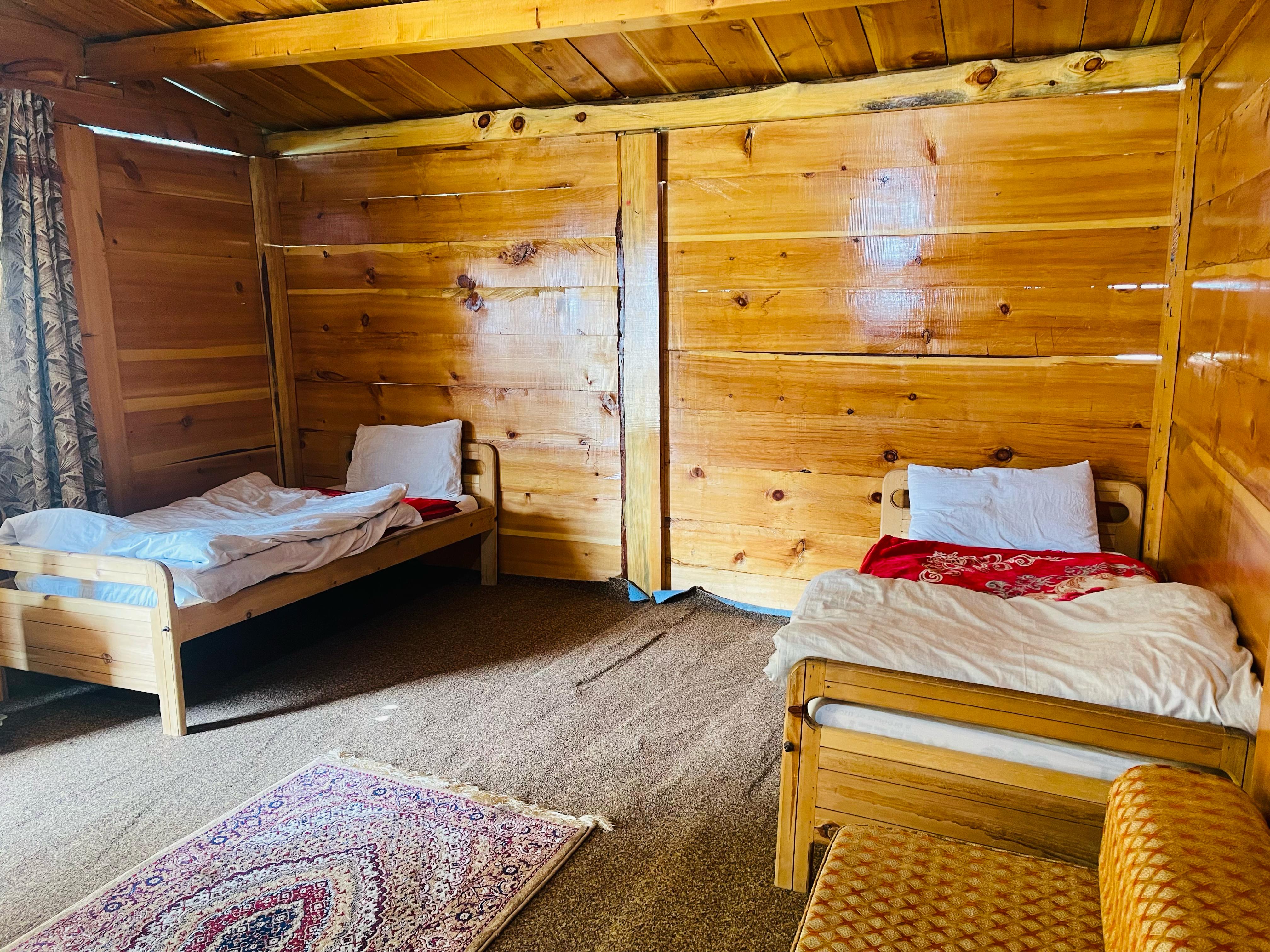 Standard wooden log cabin at Broad View Hotel.
