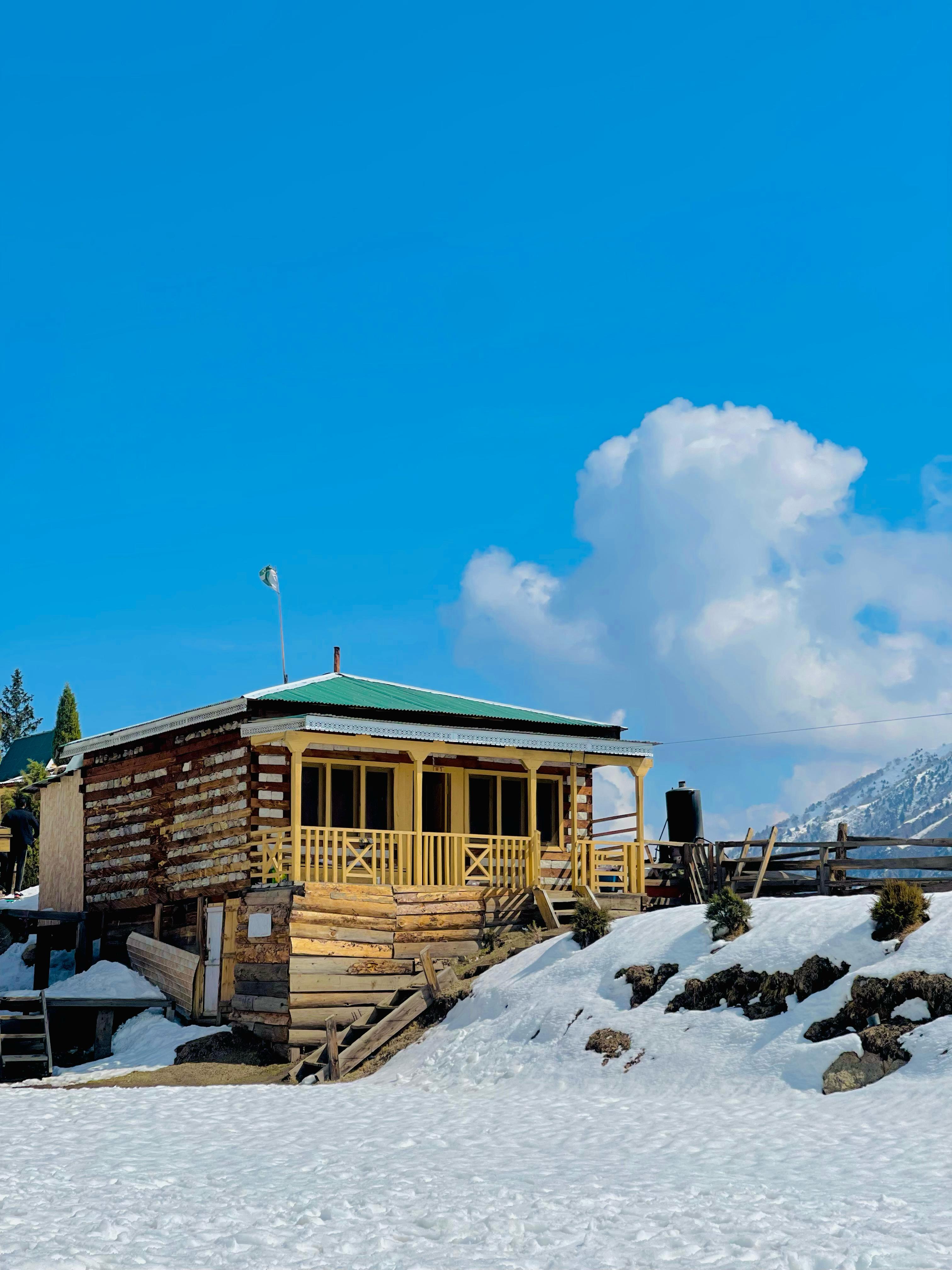 Wooden cabin row at Broad View under midday sun.